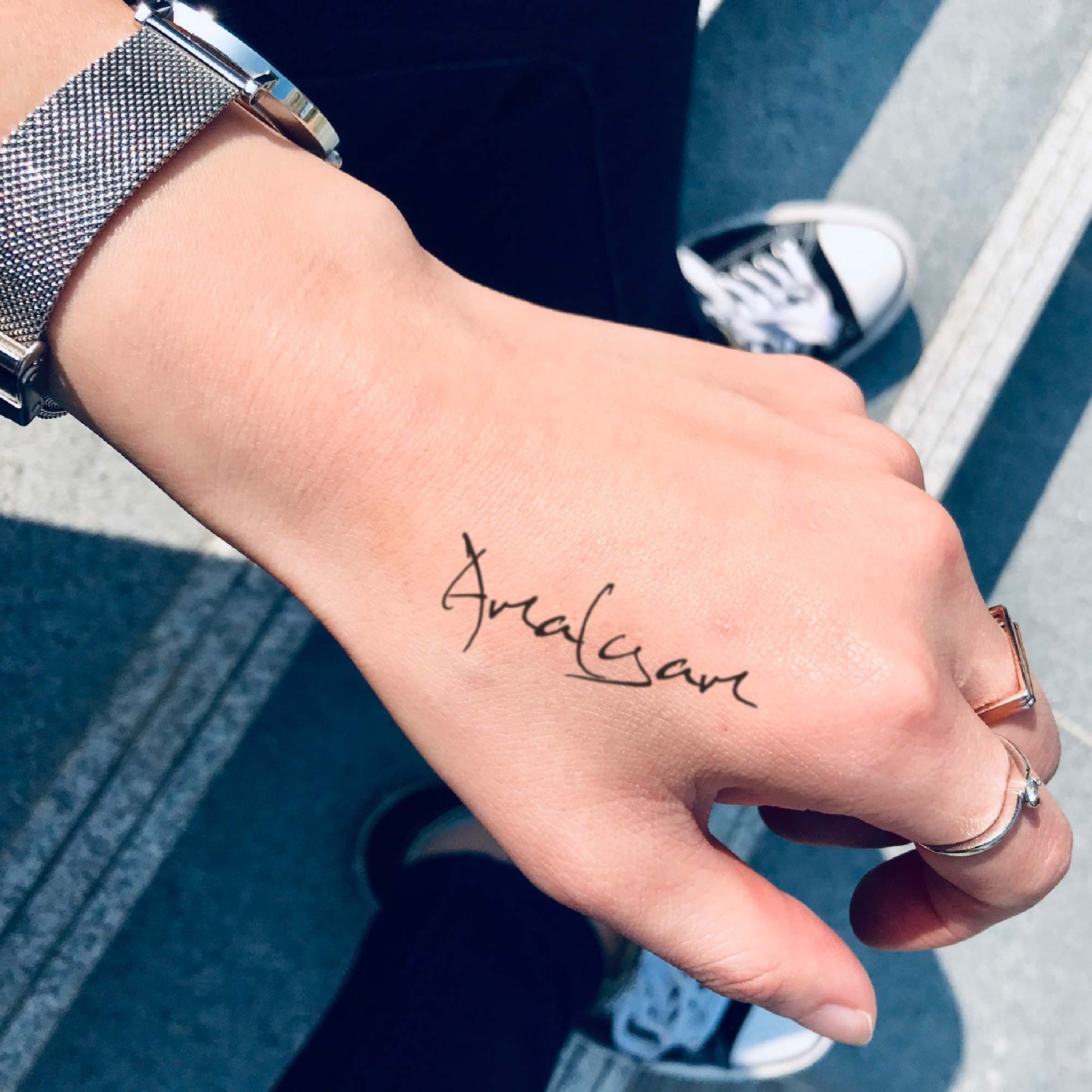 fake small amalgam lettering temporary tattoo sticker design idea on wrist hand