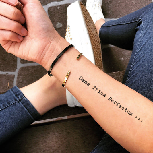 fake medium omne trium perfectum lettering temporary tattoo sticker design idea on forearm
