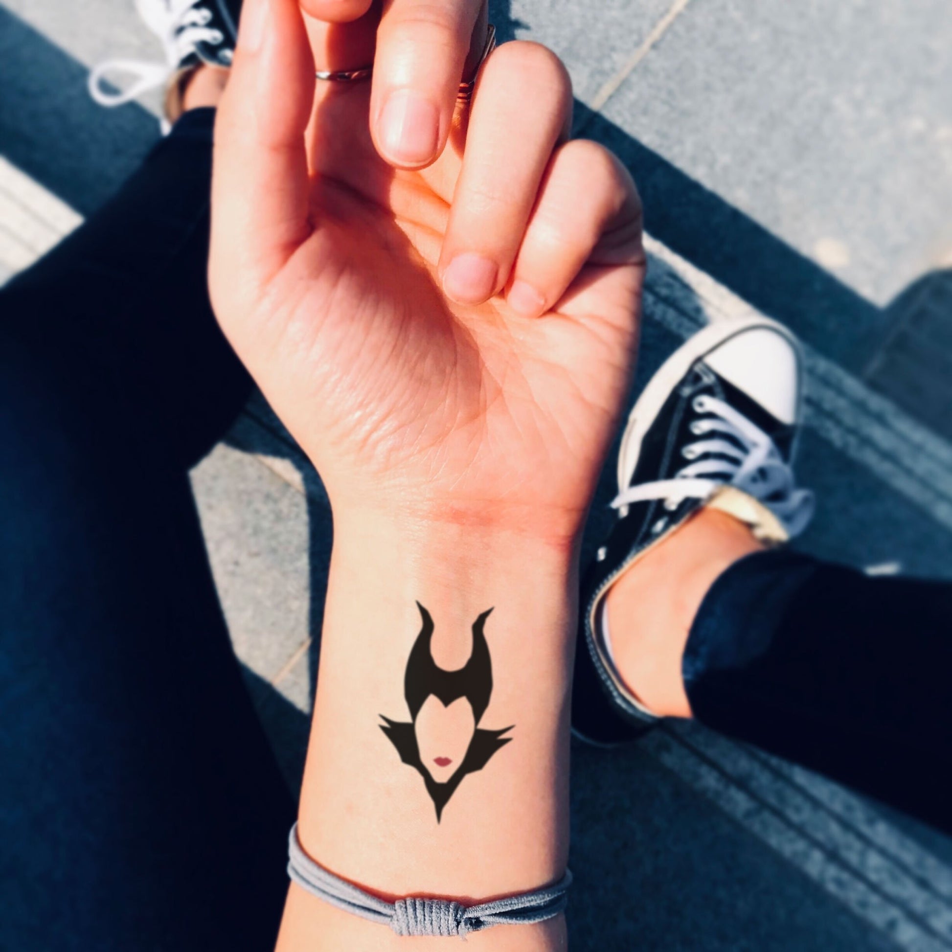 fake small disney villains maleficent minimalist temporary tattoo sticker design idea on wrist